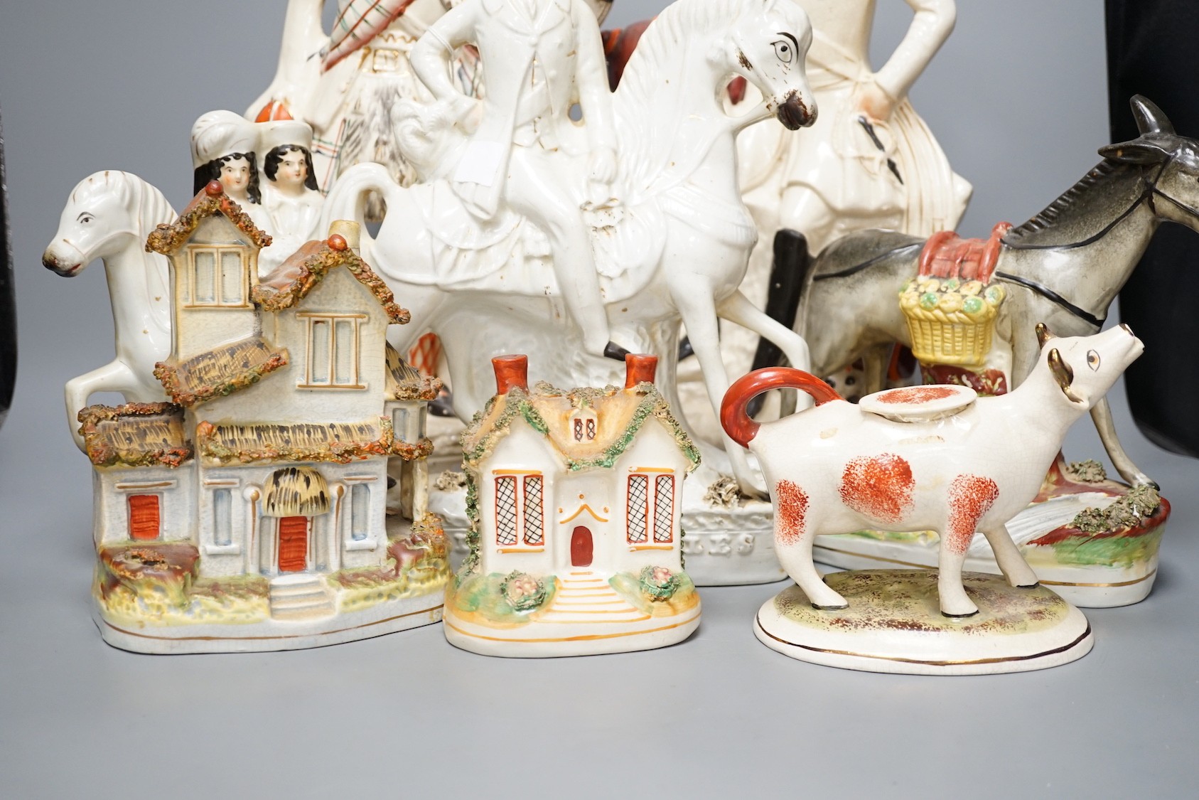 A group of Staffordshire including cottages and flatbacks